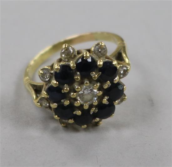 A yellow metal sapphire and diamond cluster ring, size P.